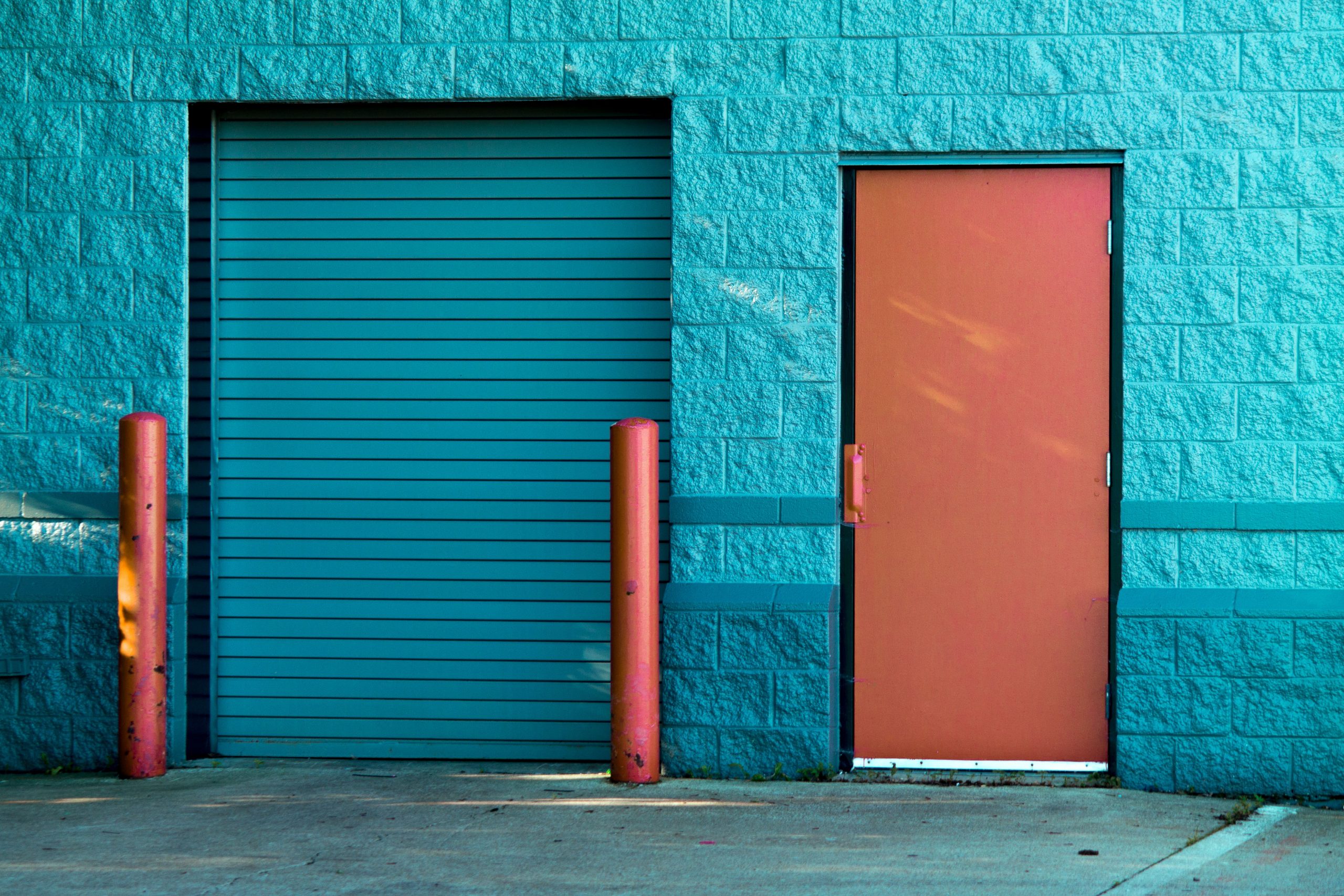 brown-panel-door-near-roll-up-gate