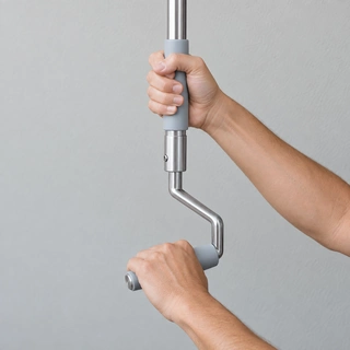 Hands operating a manual crank pole for a hurricane shutter