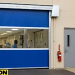 A blue vinyl roll-up door by Paylon installed at a modular medical facility, demonstrating effective quarantine zone separation with vinyl roll up barriers for healthcare use.