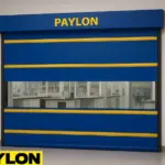 Roll up partitions in university research labs by Paylon, featuring a high-performance blue vinyl door with yellow reinforcement stripes and a clear window for visibility between lab zones