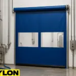Roll-Up Vinyl Door – Motorized by Paylon, shown in blue with dual vision panels inside a sanitary brewery washdown zone with stainless steel tanks