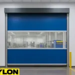 Paylon Roll-Up Vinyl Door – Motorized installed in a modern industrial facility, featuring a blue vinyl curtain with a wide clear vision panel and automated high-speed performance