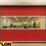 Paylon roll up vinyl doors installed in a university research lab, offering clear visibility and hygienic separation between lab zones with a vibrant red vinyl curtain and transparent center panel