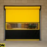 Creative use of roll up doors in livestock and agricultural barns, featuring a yellow and black PAYLON roll-up door with a transparent window revealing hay bales, tools, and a green wheelbarrow inside a barn setting