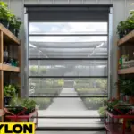 “Clear mesh roll up bug door inside a garden center aisle, allowing visibility, airflow, and pest protection between plant display areas.”