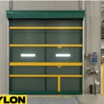 PAYLON green Roll Up Bug Door with yellow reinforcement bars used in an industrial facility for pest control and smooth workflow.