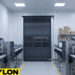 “Roll Up Bug Door providing airflow and pest protection in a beverage or brewing facility with stainless steel processing tanks.”