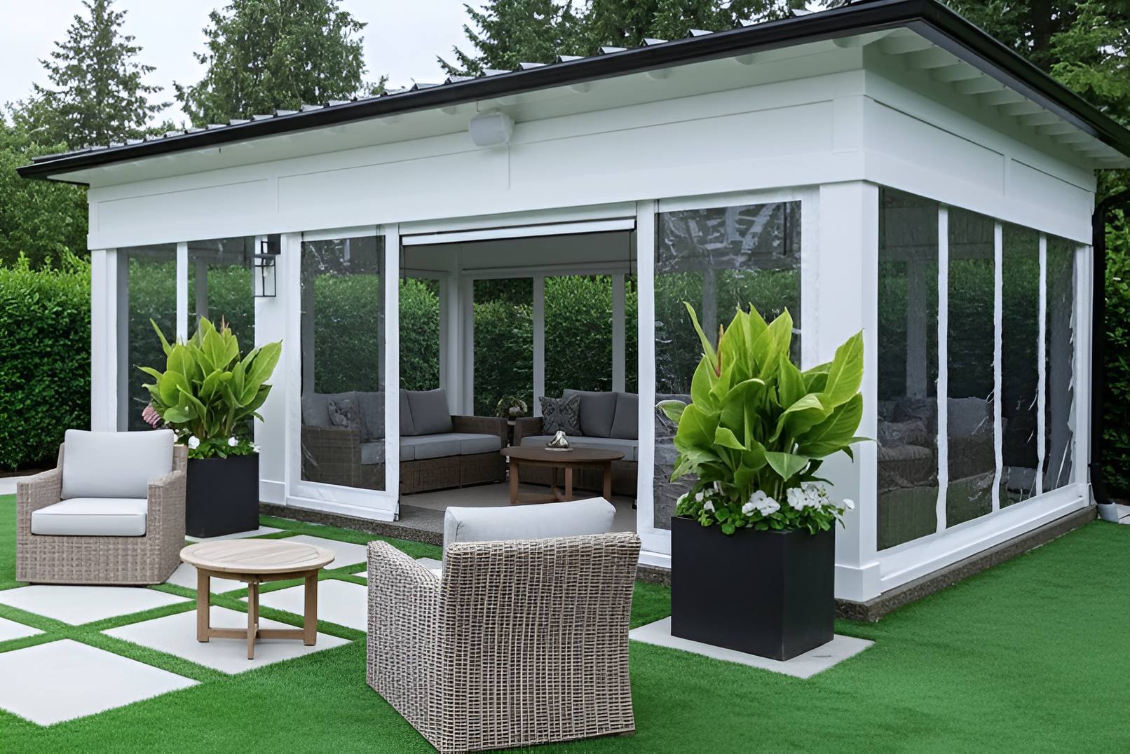 “White pavilion with clear vinyl curtains partially opened, showing a comfortable outdoor lounge space with wicker furniture and greenery,”