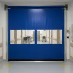 Blue roll-up vinyl door with vision panels in a healthcare corridor, supporting visibility and smooth movement between care zones.
