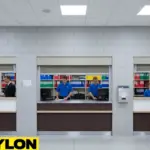 Front-facing roll-up counter door at a venue service window, separating staff workspace from customer area during active service hours