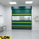 Green roll up door at clean room transition area with gowning space