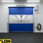 Interior dairy farm passage using a roll-up vinyl door to manage steady daily movement between work areas