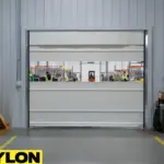 Roll-up vinyl door dividing production and packaging zones in a busy distribution facility