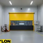 Roll-up vinyl door installed between warehouse aisles allowing forklift traffic and clear visibility