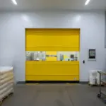 Roll-up vinyl door separating active dairy processing and storage work areas with clear access and visibility