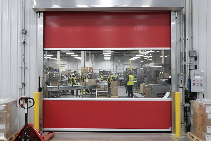 Roll-up vinyl door supporting smooth movement between warehouse aisles in a distribution center environment