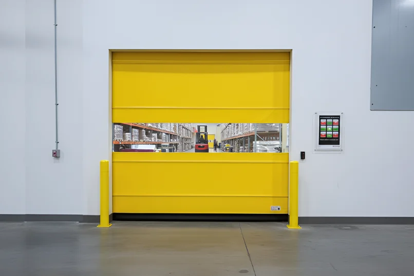 Roll-up vinyl door used in a distribution center sorting area to support continuous package movement