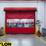 Roll-up vinyl door used in a warehouse aisle to manage pallet flow and maintain clear travel paths