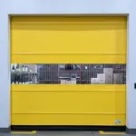 View of a bright yellow vinyl roll-up door installed in a winery storage area with visible wine bottles and boxes through a clear panel.